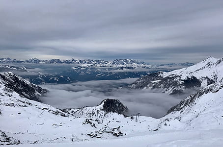 snow covered mountains under cloudy sky thumbnail