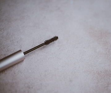 shallow focus photography of mascara brush on table thumbnail
