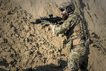man holding assault rifle wearing camouflage uniform thumbnail