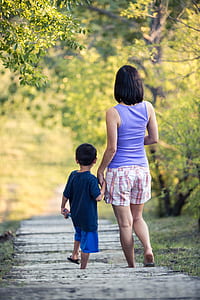 mother and child walks on road thumbnail
