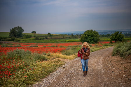 woman walking beside grass field thumbnail