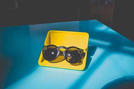 black sunglasses on yellow case thumbnail
