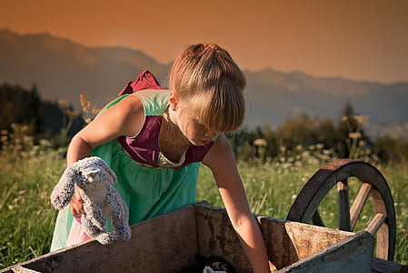 girl picking something on wheelbarrow thumbnail
