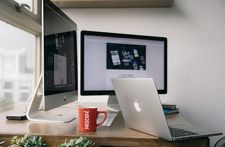 Silver Macbook on Top of Brown Wooden Table thumbnail