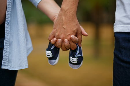 selective focus photography of persons holding hands thumbnail