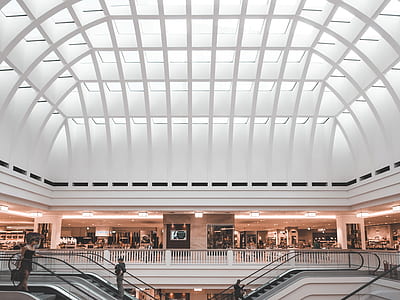 man on escalator inside concrete building thumbnail