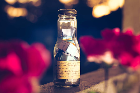 bottle with letters on top of gray concrete surface thumbnail