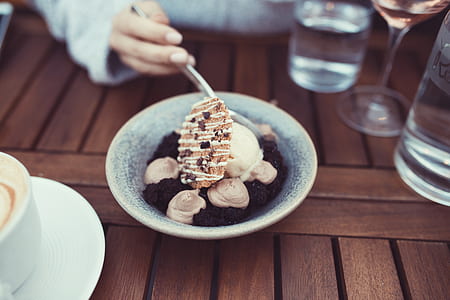 chocolate ice cream on round gray ceramic bowl on table close-up photo thumbnail