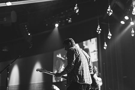 grayscale photo of man playing guitar thumbnail