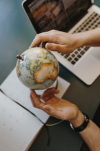Male Finger Showing A Part Of The World On An Globe thumbnail