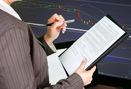 Person pointing out items on a printed report. thumbnail