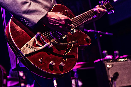 man playing guitar on stage thumbnail