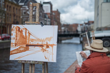 man painting a suspension bridge thumbnail