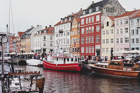 riverboats parked at dock station surrounded with buildings thumbnail