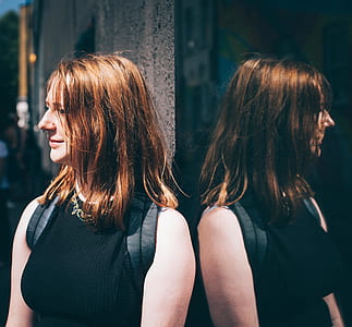Woman in Black Sleeveless Top Wearing Black Backpack thumbnail