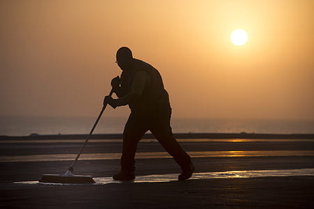 silhouette photography of man mopping a ground thumbnail