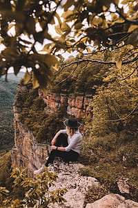 woman sitting on mountain cliff thumbnail