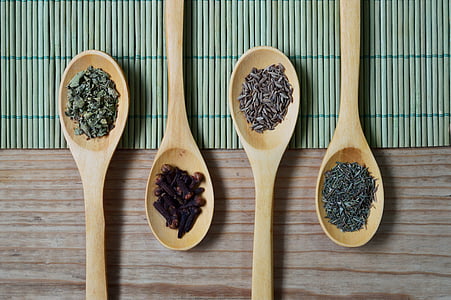 four wooden laddles with different seeds thumbnail