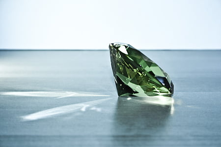 green gemstone on black surface thumbnail