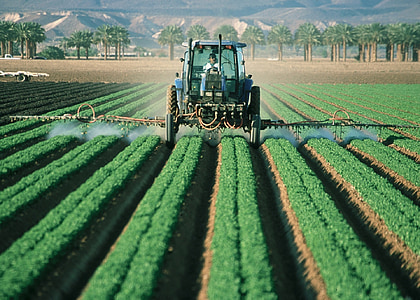 person riding on tractor farming during daytime thumbnail