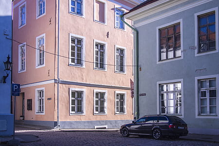 black car beside gray house during daytime thumbnail
