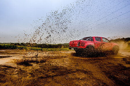 red Mitsubishi Triton crew cab truck on sand thumbnail