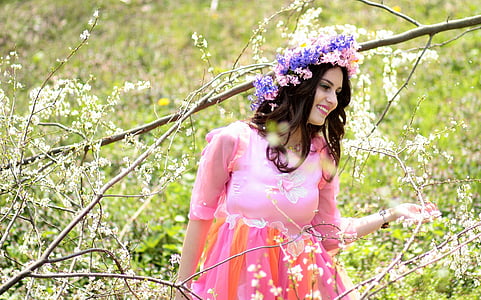 woman in pink long-sleeved dress smiling thumbnail