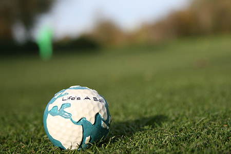 shallow focus photography of white and teal golf ball thumbnail