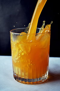 clear glass with pouring orange juice thumbnail