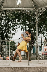 man and woman dancing inside gazebo at daytime thumbnail