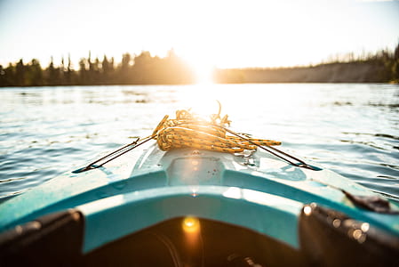 photography of kayak pointing at island at body of water thumbnail