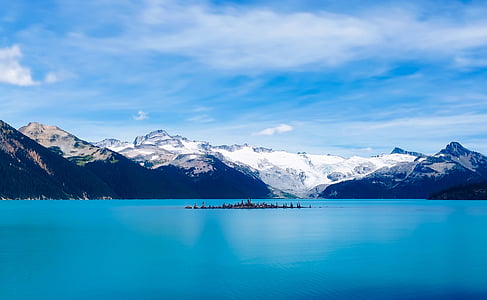photo of black and white mountains near body of water thumbnail