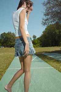 woman walking on pathway during daytime thumbnail