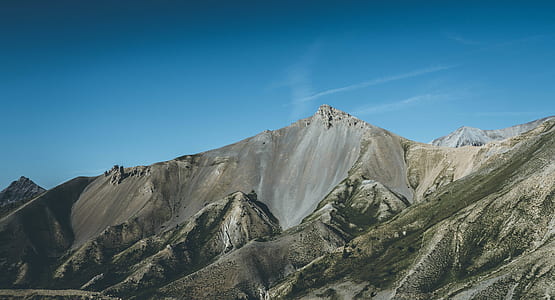 mountain range under blue skies thumbnail