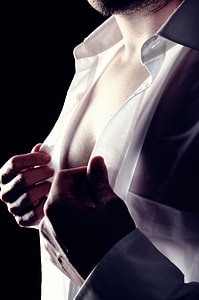 man buttoning up white dress shirt thumbnail