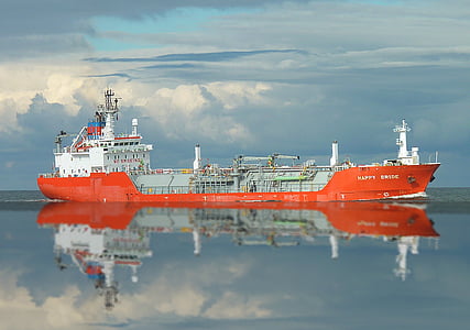 orange and white ship on ocean thumbnail
