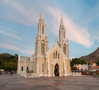beige cathedral beside mountain thumbnail