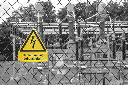 selective colored photography of yellow signage on cyclone fence thumbnail