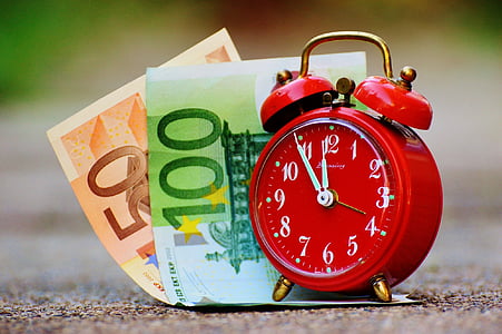 20 and 100 euro banknotes and red alarm clock with bell thumbnail