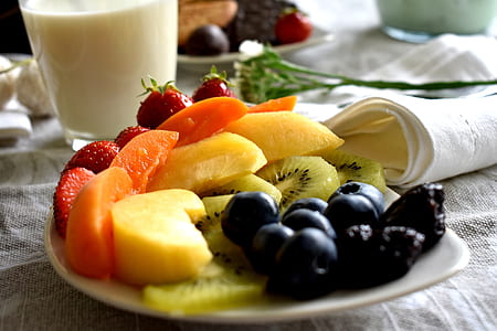 assorted sliced fruits on white ceramic plate thumbnail