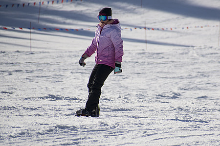 man wearing pink jacket snowboarding thumbnail