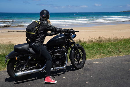 man riding on motorcycle in front of the beach during daytime thumbnail