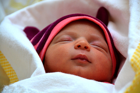baby lying on white blanket thumbnail