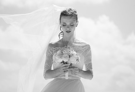 grayscale photo of woman holding flowers thumbnail