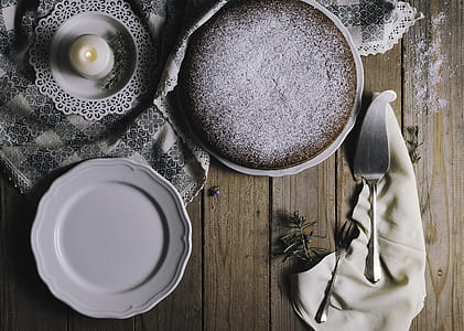 white ceramic saucer near silver fork thumbnail