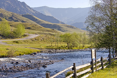 photo of body of water near mountain thumbnail