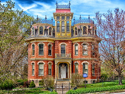 brown concrete mansion surrounded by trees thumbnail