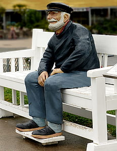 man sitting on white wooden bench thumbnail