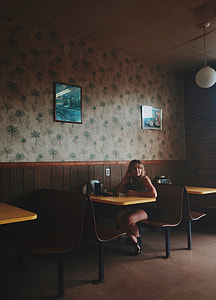 woman sitting on chair inside restaurant thumbnail