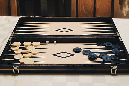 beige and black backgammon set on table thumbnail